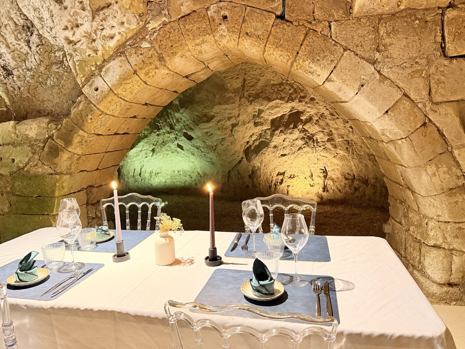Une table aux chandelles sous les voûtes du Pressoir